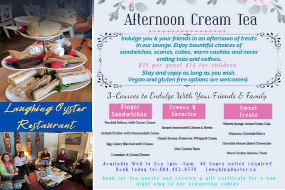 Afternoon cream tea spread with pastries, sandwiches, and beverages on decorative table.